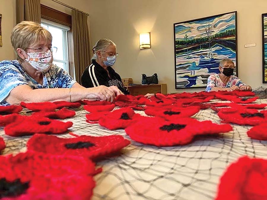 Volunteers craft poppies for Remembrance Day display post image