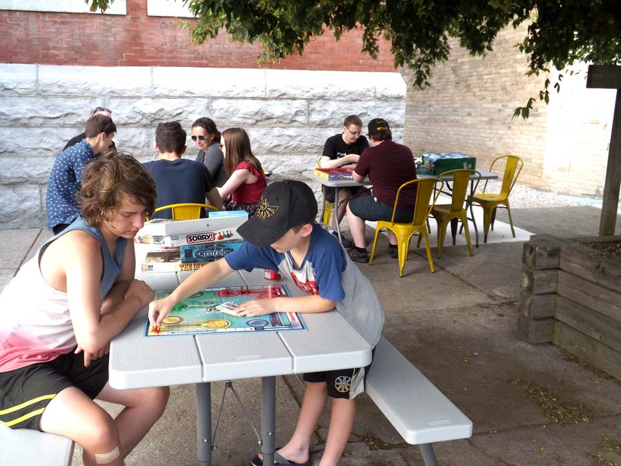 Taking turns at outdoor board game night in Harriston