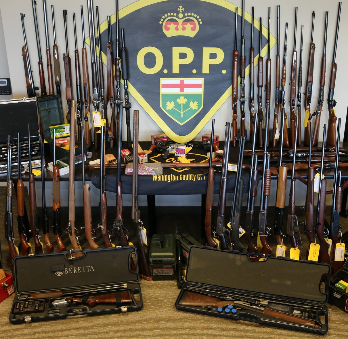 Police charge two men, recover almost 60 stolen guns