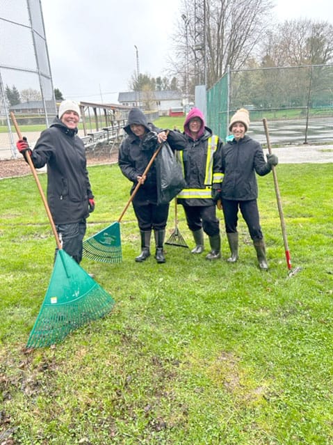 Volunteers help with ball diamond cleanup