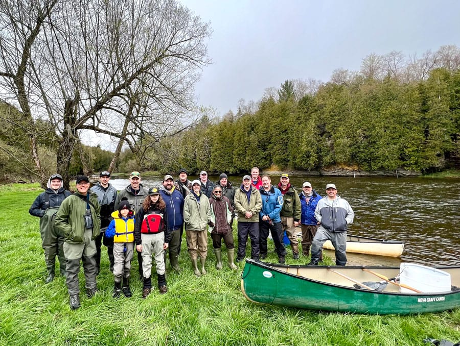 Volunteers stock the Grand River with 16,000 brown trout