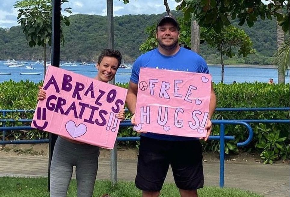 Couple offering free hugs to spread love, connection