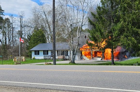 Highway 7 fire destroys garage, damages home