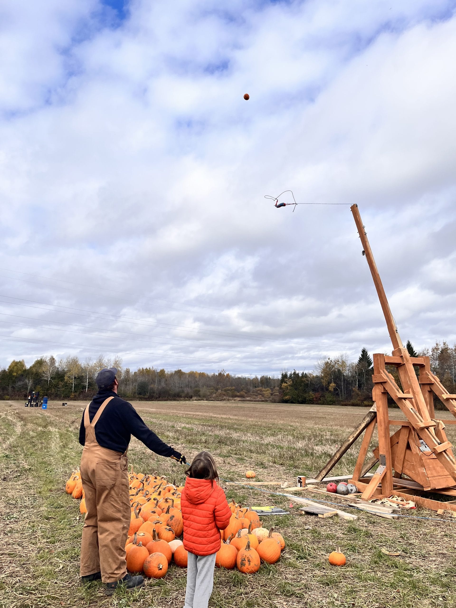 Handmade trebuchet sends pumpkins flying